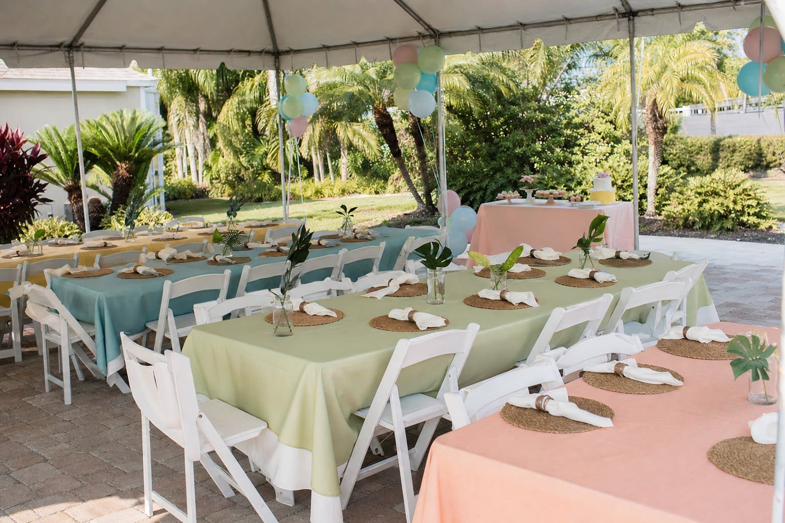 Outdoor tented birthday party setup with colorful linens and balloons by Creative Events & Rentals