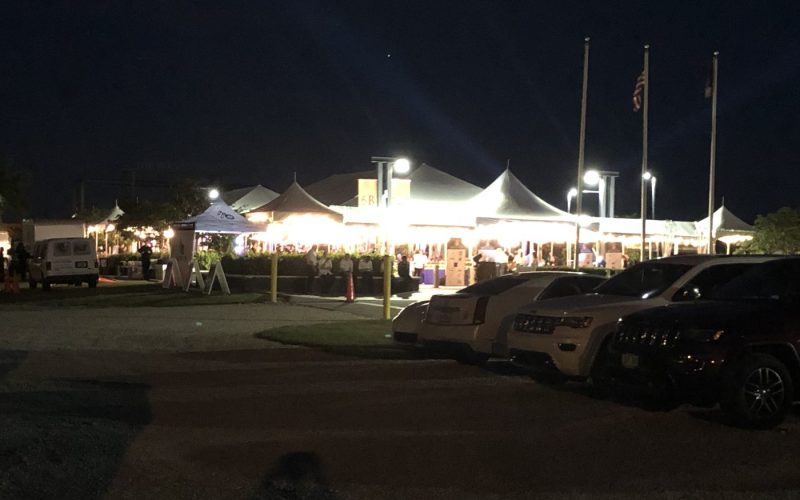 Lit event tent at night, waterfront, by Creative Events & Rentals